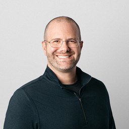 Portrait of a man, smiling at the camera.